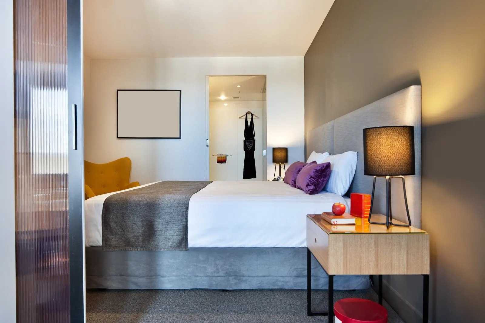 Refined hotel guest room with a neatly prepared bed and natural light