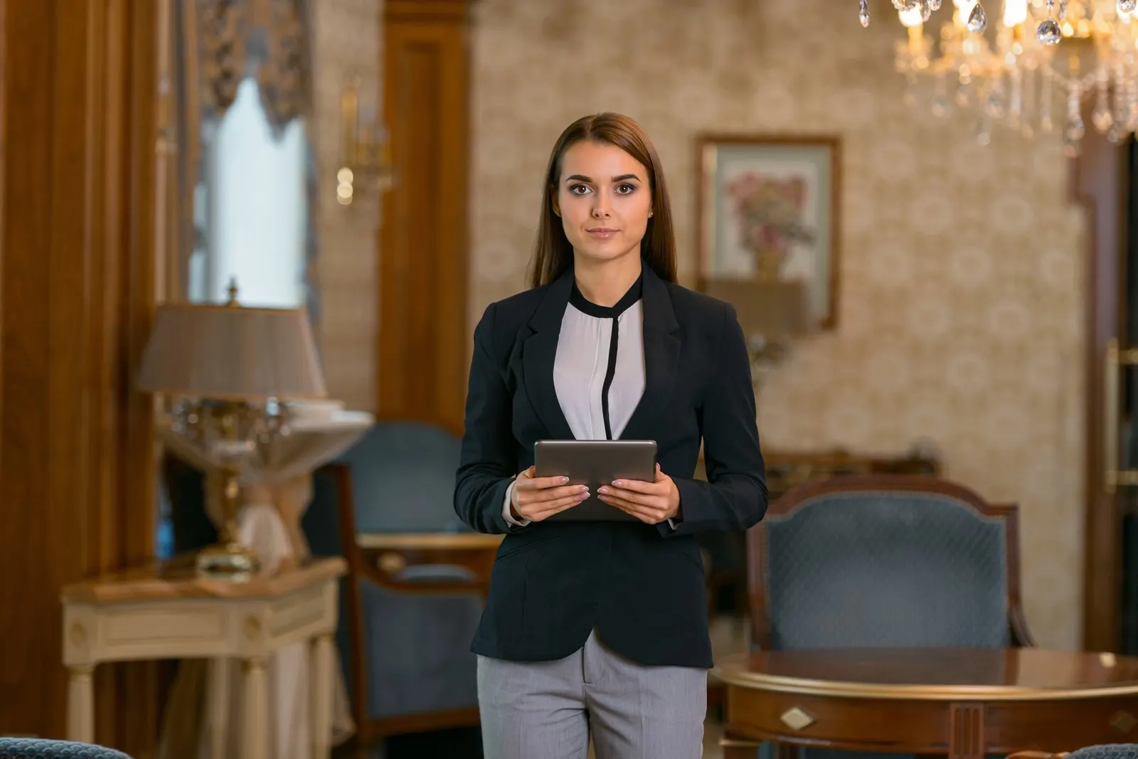 Hotel manager using a tablet while overseeing the property